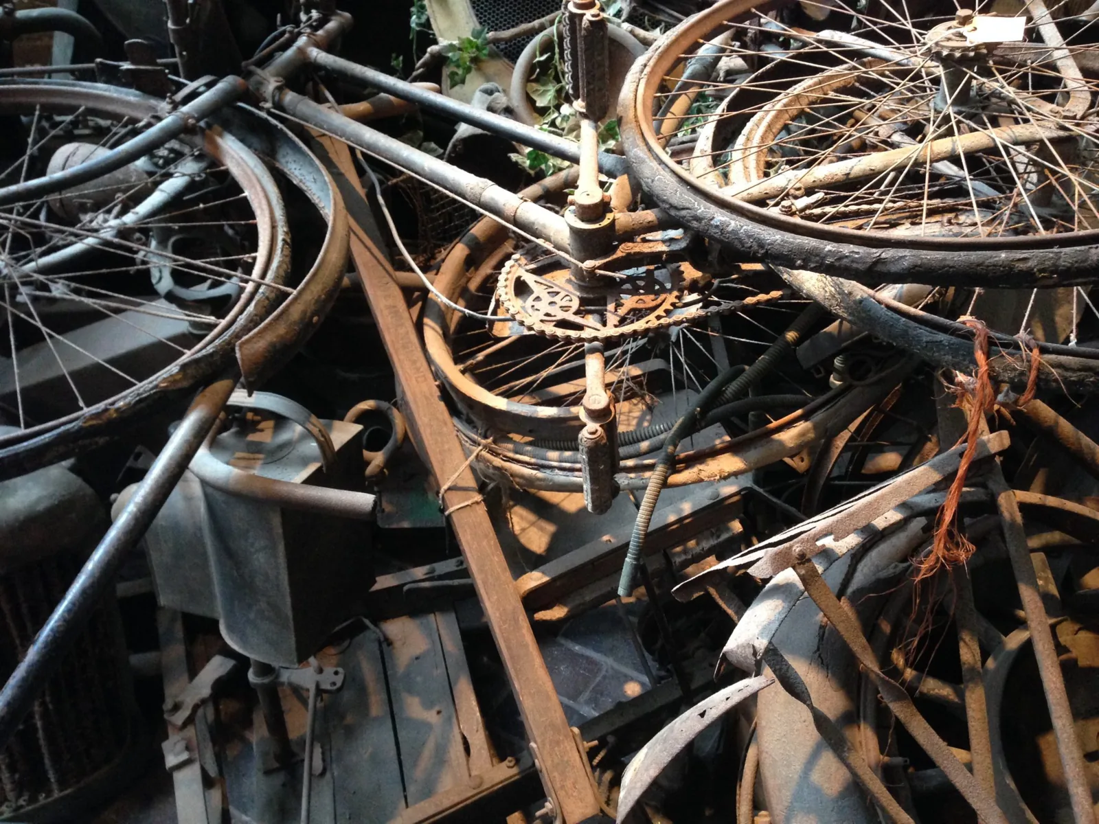 A dense tangle of discarded scrap metal, bicycle frames and wheels in a scrap yard