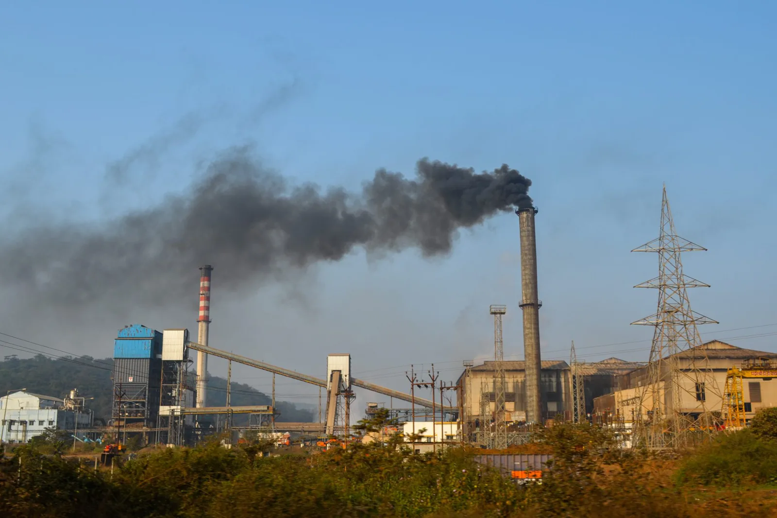 General environmental duty compliance in Victoria: smoke rising from an industrial plant stack against a clear sky