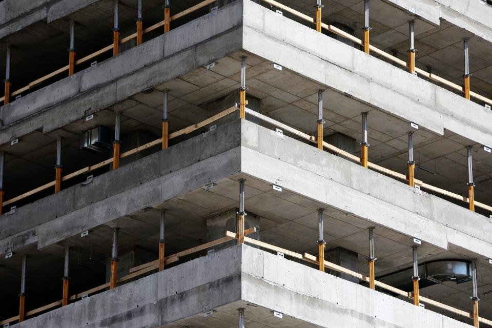 Multi-storey reinforced concrete structure under construction showing repeating floor plates