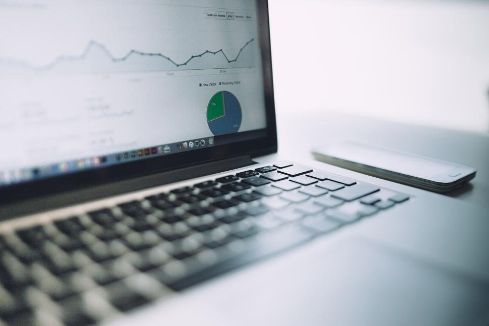 A laptop on a desk showing a live dashboard of charts, an example of what you get when you automate Excel reports