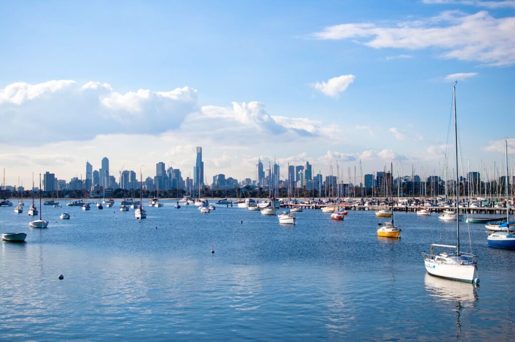 Melbourne city skyline seen across the water from St Kilda marina on a clear day